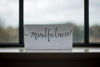 mindfulness printed paper near window by Lesly Juarez courtesy of Unsplash.