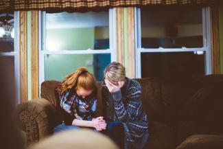 man and woman sitting on sofa in a room by Ben White courtesy of Unsplash.