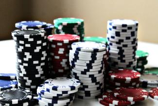 stacked poker chips with different colors by Amanda Jones courtesy of Unsplash.