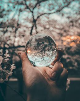 person holding round glass ball by Yeshi Kangrang courtesy of Unsplash.