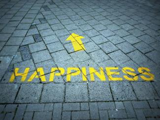 a brick sidewalk with a yellow arrow painted on it by D Jonez courtesy of Unsplash.