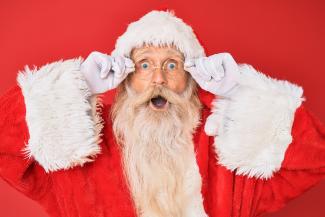 santa claus with red background by krakenimages courtesy of Unsplash.