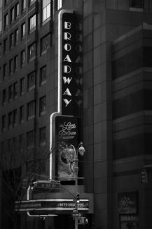 a black and white photo of a broadway sign by Quentin BASNIER courtesy of Unsplash.