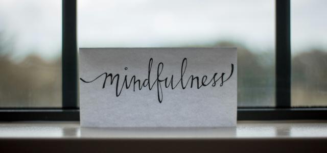 mindfulness printed paper near window by Lesly Juarez courtesy of Unsplash.