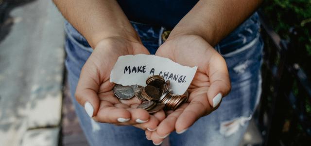 person showing both hands with make a change note and coins by Katt Yukawa courtesy of Unsplash.